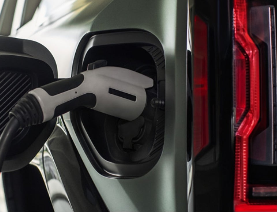 Close up of charging port with charger plugged in on a GMC Hummer EV SUV - O'Neil GMC in Warminster PA